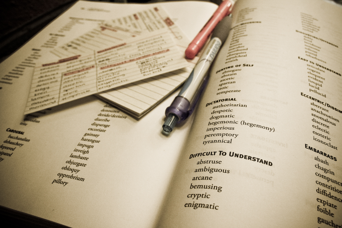 Hand written flash cards lying on a vocabulary book