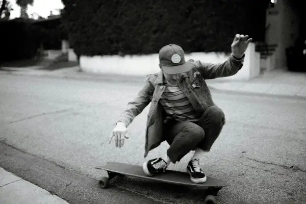 A man balancing on a longboard